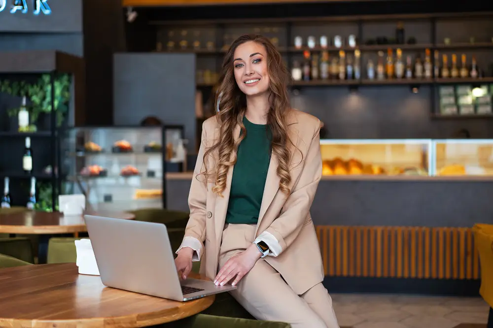 A woman working on a laptop in a restaurant